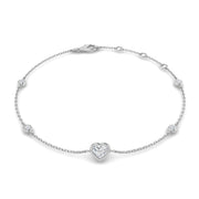 An 18K gold bracelet featuring a heart-shaped diamond as the central piece, with smaller round diamonds set in a station design along the chain.